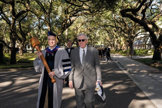 Chief Marshal Fred Oswald and Board of Trustees Chair Robert T. Ladd lead a group from Huff House to the Wiess President’s House to formally summon Reginald DesRoches to the investiture.
